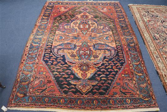 A North West Persian indigo ground rug, centred by a large polychrome medallion, 215cm x 160cm